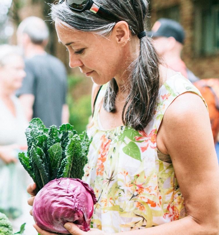 Woman holding vegetables at farmers market