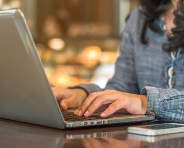 Person typing on laptop at desk